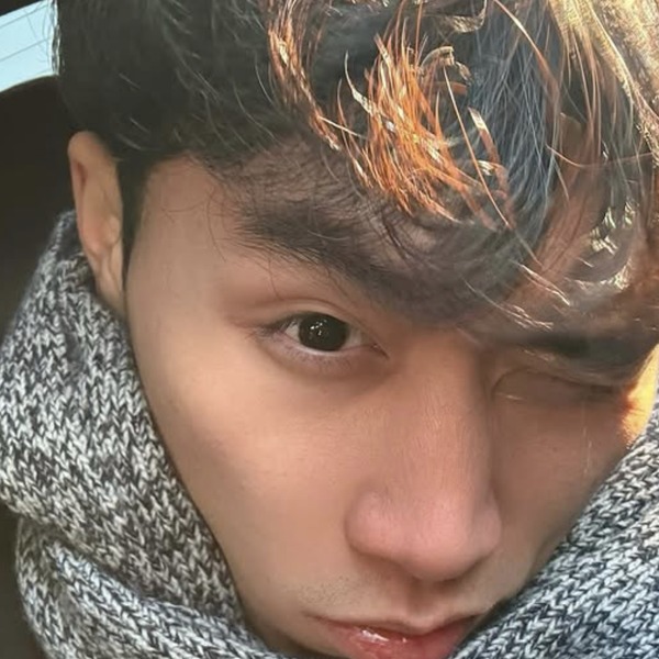 Benny Wang — selfie with orange-tinted hair and grey scarf.