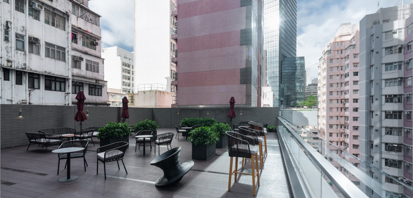 The Hive Causeway Bay — the open-air sky-garden terrace with the Hong Kong skyline behind.