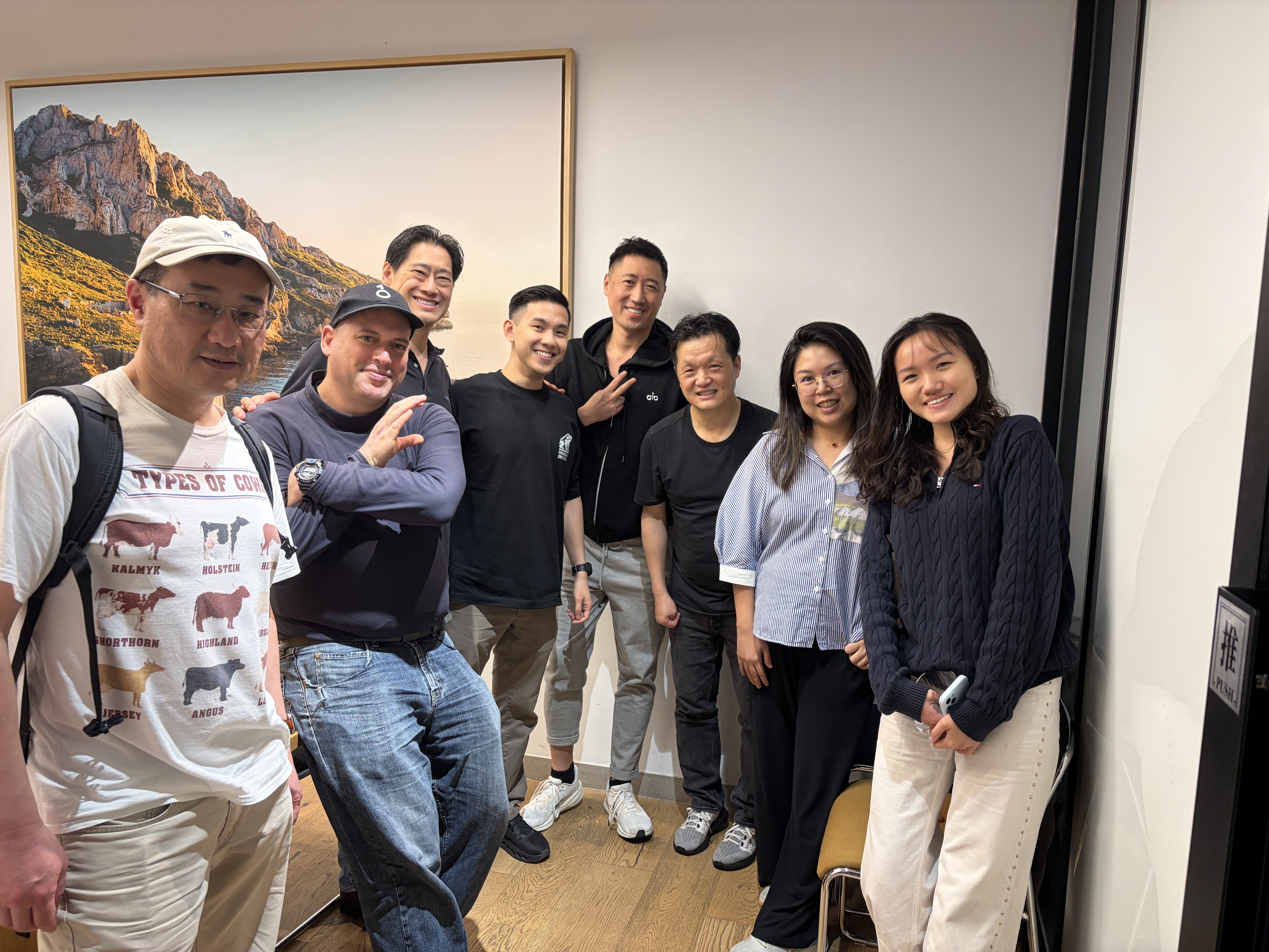 Group photo of 8 attendees posing together after the meetup