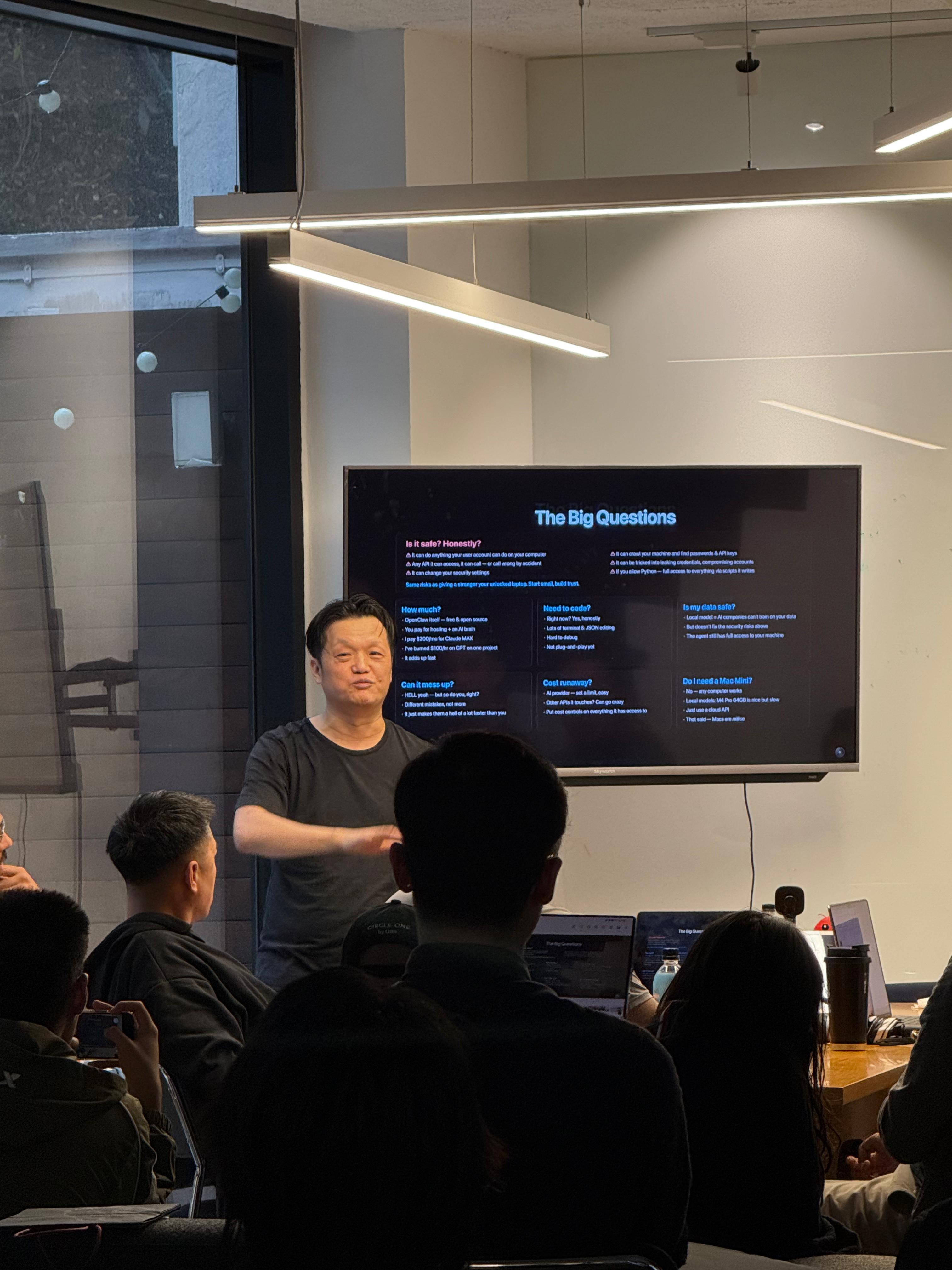 Hanley presenting The Big Questions slide to packed audience