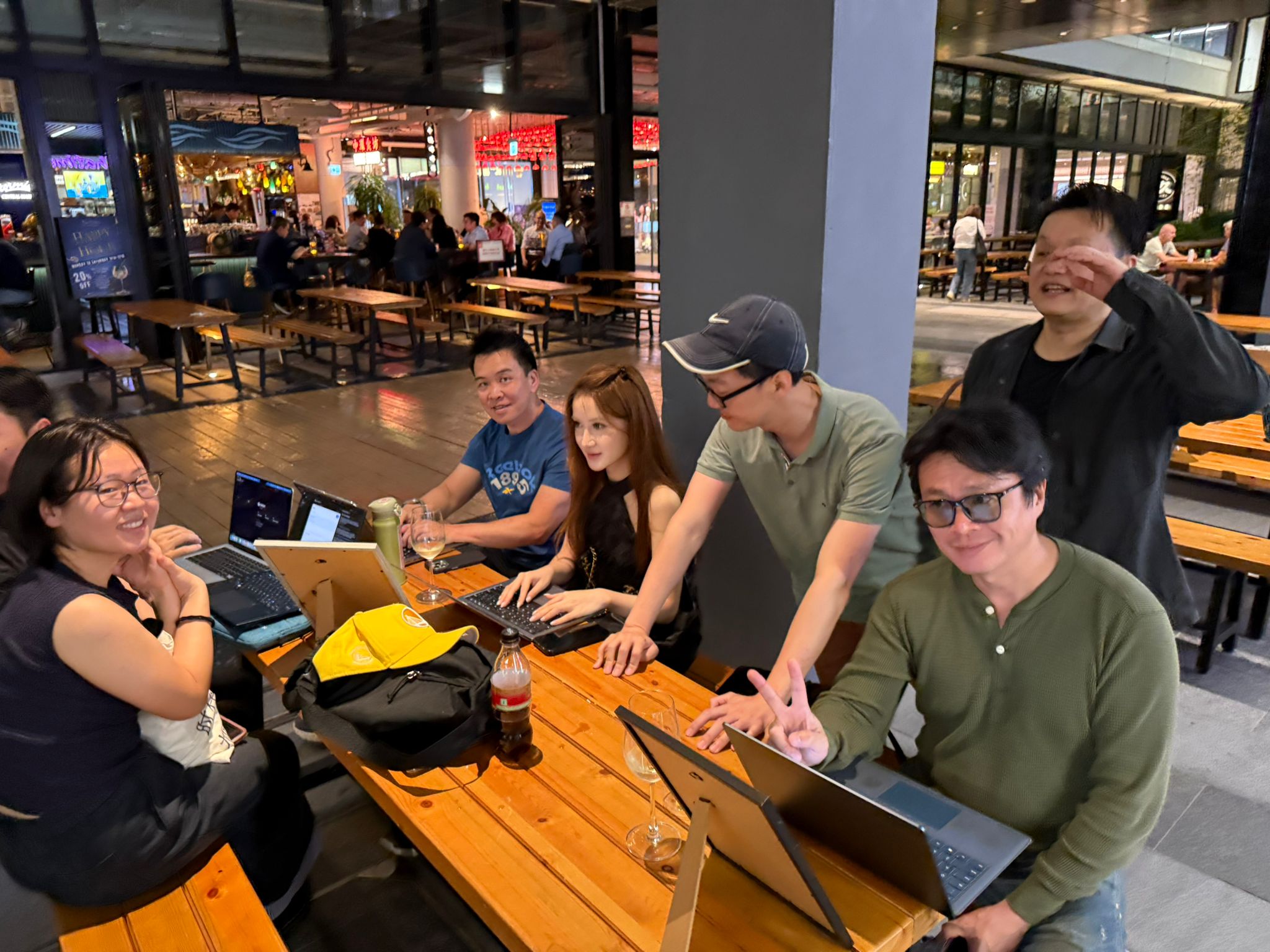 Close-up of builders coding at a wooden table