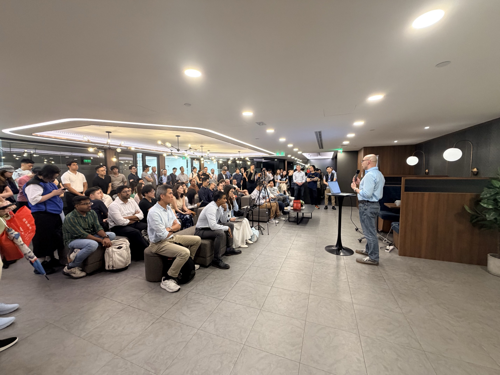 Dale Satre addressing the packed audience from the side