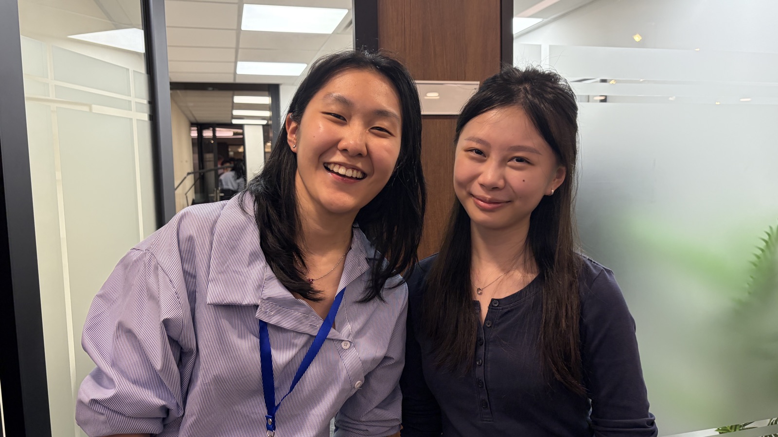 Two attendees smiling, close up