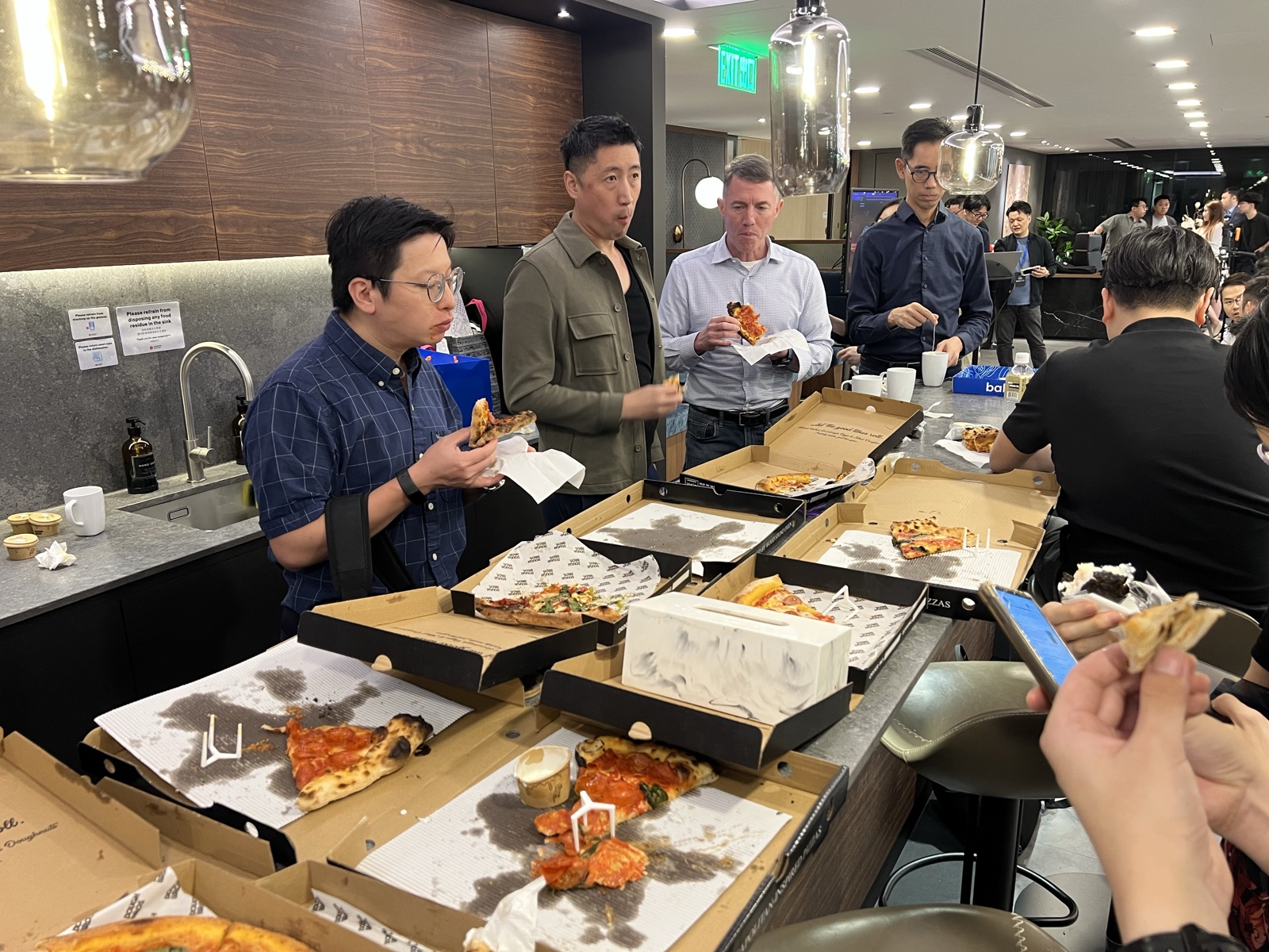 Attendees grabbing pizza after the talks