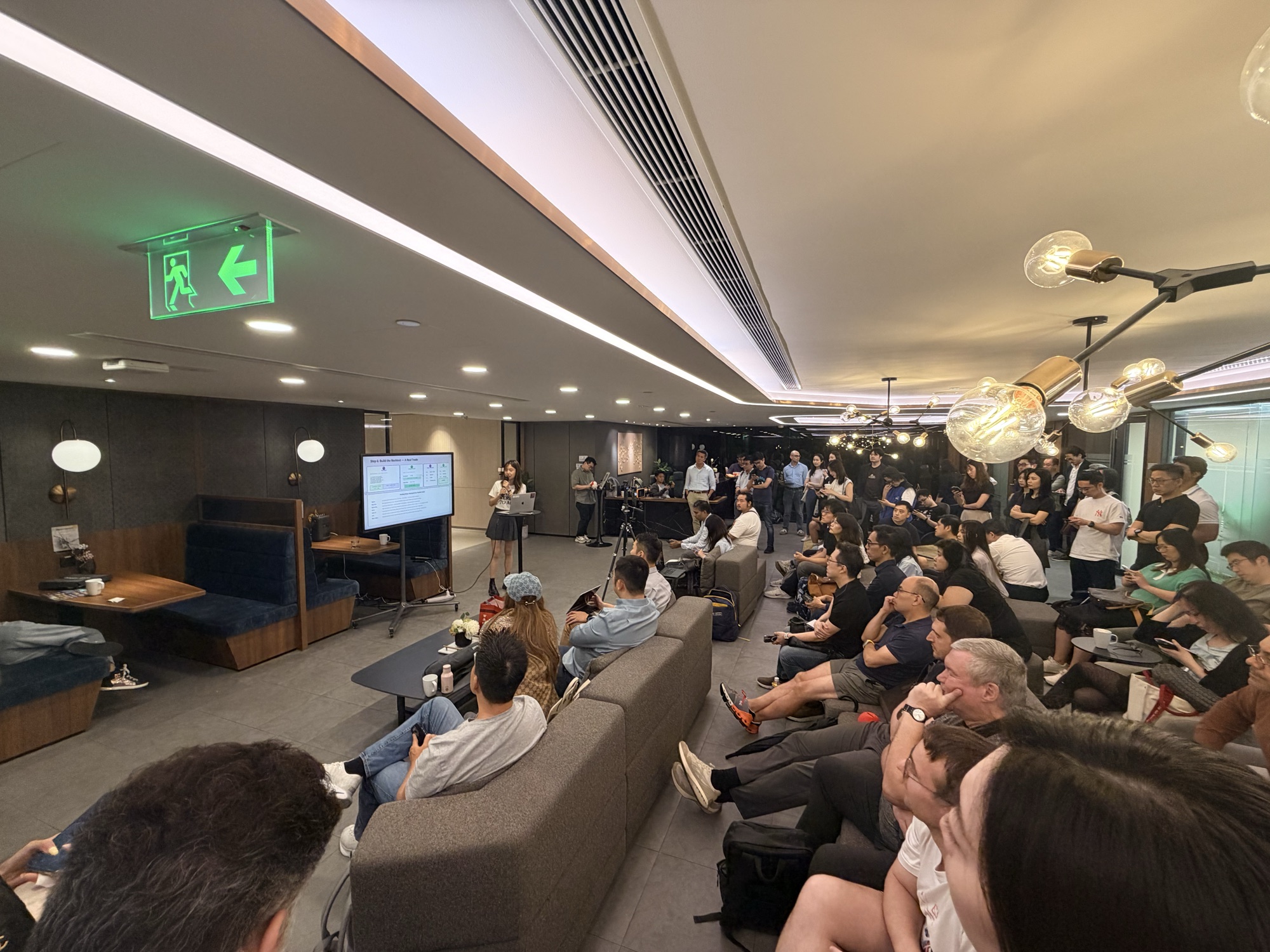 The lounge at Compass Offices filled with attendees facing the speaker